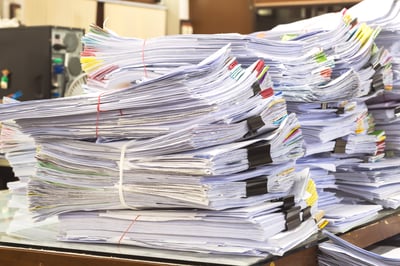 stacks of paperwork for freight audit & pay